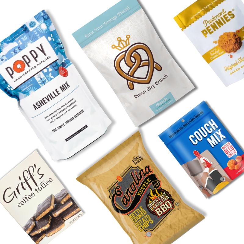 Flat lay of the Carolina Snack Box contents including NC-made popcorn, chips, granola, cookies, toffee, and snack mix, arranged neatly on a white background