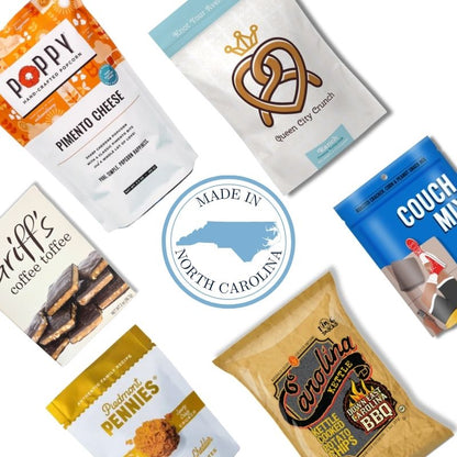 Flat lay of the Carolina Snack Box contents including NC-made popcorn, chips, granola, cookies, toffee, and snack mix, arranged neatly on a white background