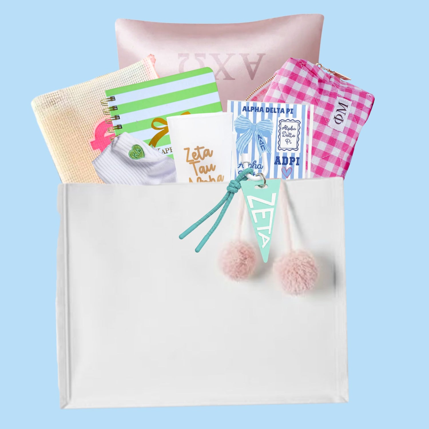 UNC bid day gift bag contents including satin pillowcase, gingham cosmetic bag, sorority notebook, socks, stickers, and pennant keychain
