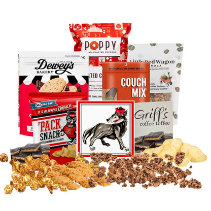 NC State-themed gift basket contents arranged on a countertop with small piles of each snack in front, showcasing red-packaged North Carolina-made gourmet treats